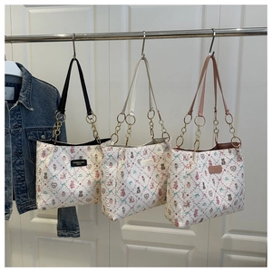 Three bear print tote bags in black, white, and pink featuring gold chain straps