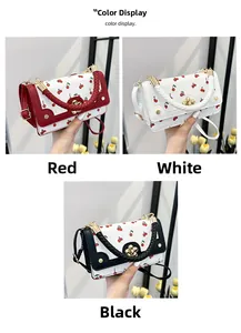 Detailed view of cherry print mini square bags with woven handles and floral gold clasps