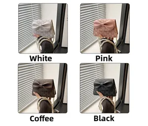 Detail shot of mini pearl bags with bow accents in white, pink, brown and black colors