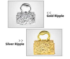 Macro detail of acrylic evening bags with wavy texture and metallic U-shaped handles