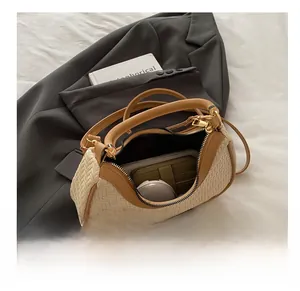 Interior view of beige woven handbag showing storage space for phone and makeup