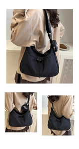 Black nylon tote bag set with drawstring detail and a ZME logo round coin purse attachment