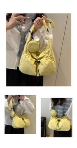 Detail of yellow nylon crossbody bag with detachable round coin purse and drawstring pocket