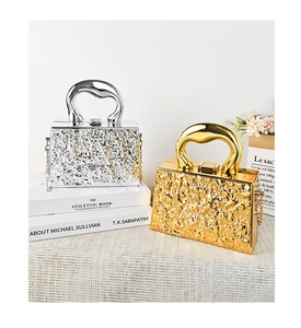 Detail view of silver and gold acrylic evening bags with irregular lava texture