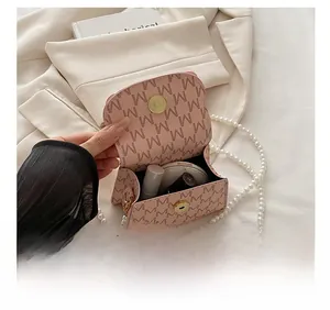 Pink mini square bag with pearl chain showing space for lipstick and makeup compact