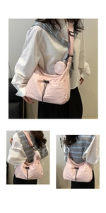 Detail of pink pleated tote bag featuring black drawstring buckle and ZME round mini pouch