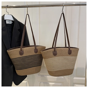 Détail de sacs fourre-tout en paille tissée à rayures avec bandoulières en cuir PU