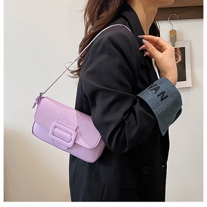 Side view of lavender baguette shoulder bag with large square buckle on model