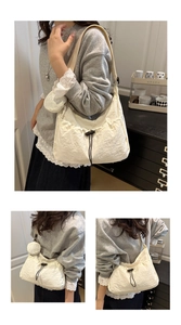 Detailed close-up of white pleated nylon tote bag with drawstring and mini round coin purse