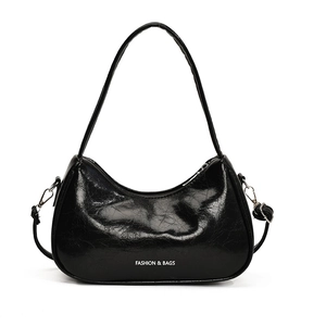 Minimalist black patent leather underarm bag with glossy texture and shoulder strap