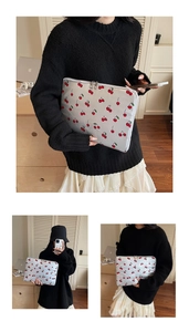 Detailed view of cherry print laptop sleeve with secure double zipper closure