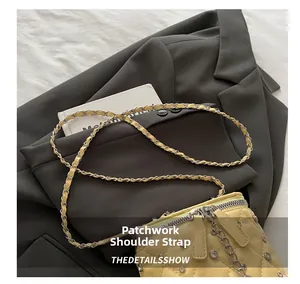 Close-up view of the elegant spliced chain shoulder strap on a yellow quilted bag