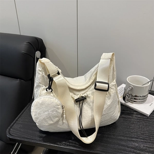 Minimalist cream nylon tote bag with drawstring pocket and a round mini coin purse