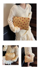Detail of yellow cherry print laptop sleeve shown in a lifestyle staircase setting