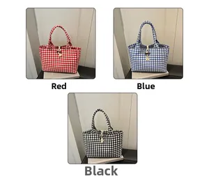 Close-up of Vichy check canvas tote bags in red blue and black with wooden button closure