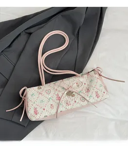 Close-up of jacquard tote with pink rabbit prints, heart charms and bow details