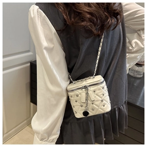 Elegant white quilted crossbody bag featuring silver rivet details and chain strap