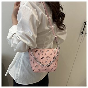Detail of pink crossbody bag featuring cartoon bear prints and decorative silver chain strap