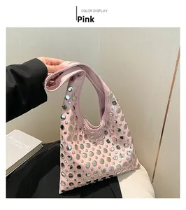 Detailed view of pink hobo bucket bag with silver studs and chic shoulder strap