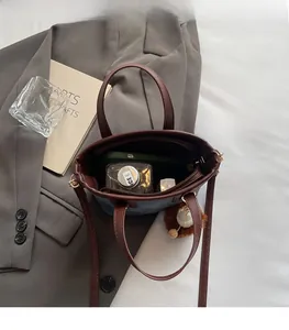 Interior view of small denim tote bag showing spacious capacity and inner pocket