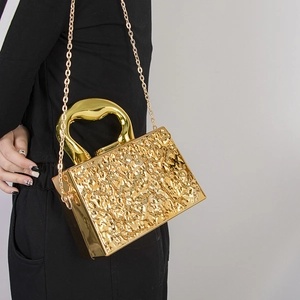 Golden acrylic box evening bag with metallic texture, gold chain and unique top handle
