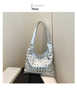 Detail of silver bucket bag featuring full rivet embellishments and metallic texture