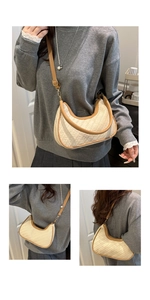 Close-up of beige woven texture and brown leather strap on minimalist hobo shoulder bag