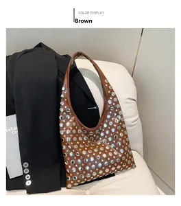 Detailed close-up of brown Hobo bucket bag featuring large silver metal rivets and leather texture