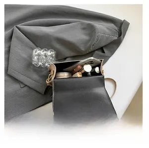 Interior view of minimalist crossbody bag showing space for phone and cosmetics