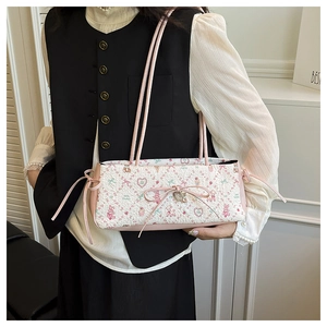 Detail of pink floral shoulder bag with cartoon bear prints and cute bow accents