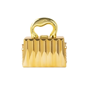 Chic gold acrylic evening clutch with vertical ripple texture and a unique wave handle