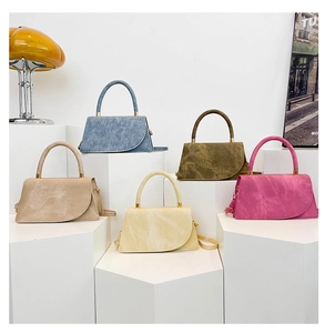 Five assorted minimalist handbags in denim blue, olive, and pastel tones on display