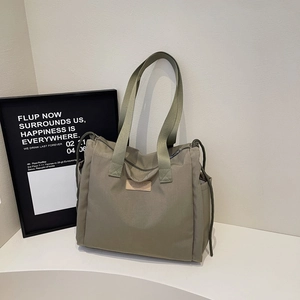 Large dark grey nylon tote bag with drawstring detail and adjustable shoulder strap