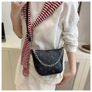Detail of black leather bucket bag with silver chain strap and monogram pattern