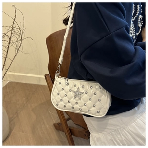 Detail of white quilted faux leather shoulder bag with star and rhinestone studs