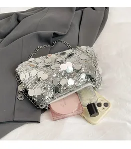 Detail of silver sequin chain bag showing interior capacity for phone and perfume