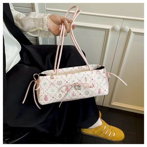 Detail of pink floral tote bag with cute cartoon bear patterns and decorative bows
