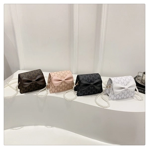 Detail of mini bow bags in four colors featuring pearl chains and M-monogram texture