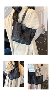 Detail view of black tote bag with white polka dots and butterfly texture featuring Fashion logo