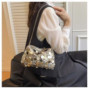 Detail of shimmering gold and silver large sequins on a stylish chain crossbody bag