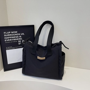 Large capacity black canvas tote bag with side pockets and leather logo for daily commute