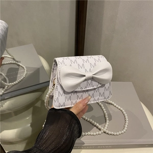 Girl's white pearl handle crossbody bag with large bow and letter M print pattern
