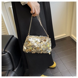 Detail of shimmering gold sequin evening bag with elegant metallic chain strap