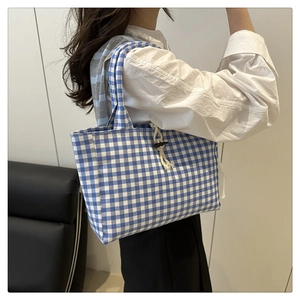 Detail of blue and white checkered canvas tote with vintage wooden horn buckle closure