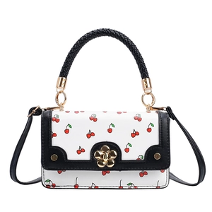 Stylish white crossbody bag with cherry floral print and black handles in front view