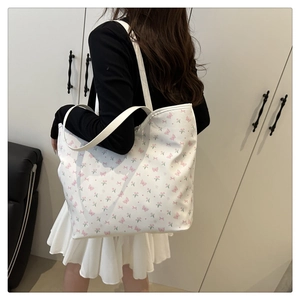 Detail view of large tote bag with fresh floral tulip and pink butterfly print pattern
