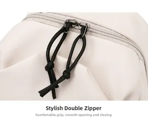 Detail of high-density cream canvas chest bag featuring smooth dual black cord zippers