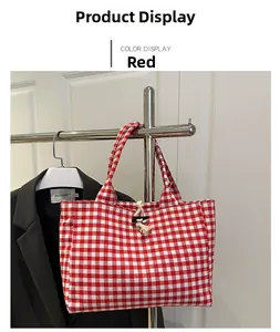 Detail of red and white checkered canvas tote bag with a unique horn buckle rope closure