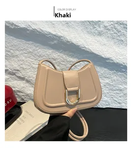 Detail of khaki crescent shoulder bag with glossy PU finish and gold D-ring buckle