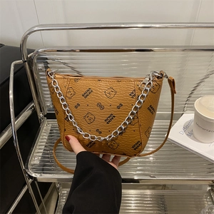 Brown bucket bag with bear print and silver chain strap for shoulder or crossbody use